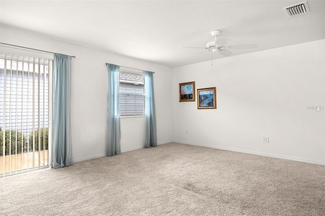 spare room featuring carpet floors and ceiling fan