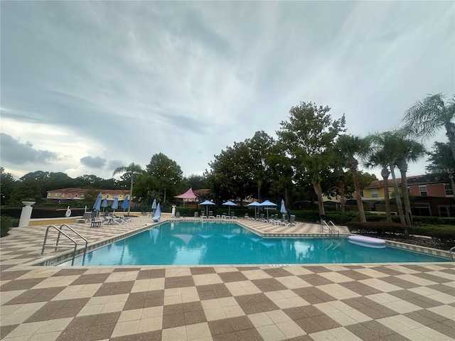 view of swimming pool with a patio