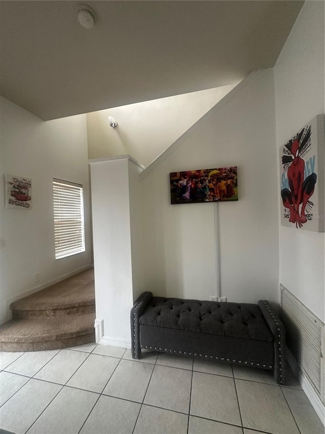 sitting room featuring lofted ceiling and light tile patterned floors