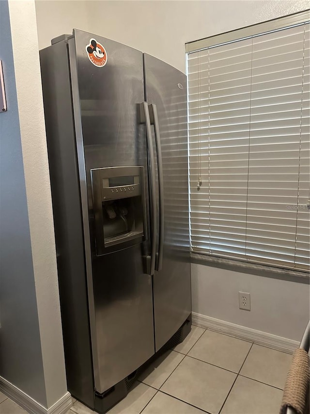 kitchen featuring stainless steel fridge and light tile patterned floors