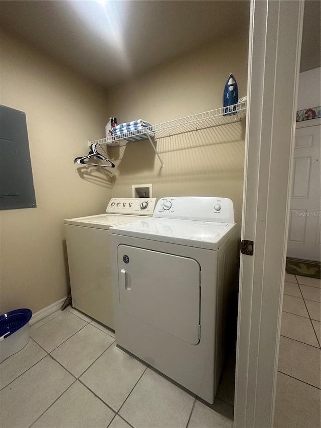 clothes washing area featuring separate washer and dryer, electric panel, and light tile patterned flooring