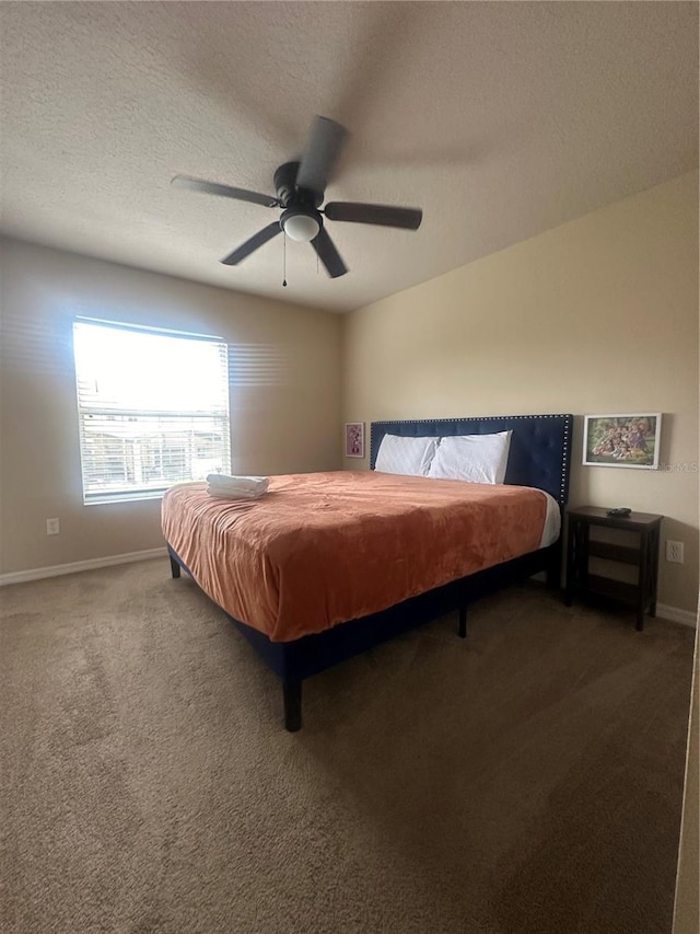 bedroom with carpet flooring, ceiling fan, and a textured ceiling