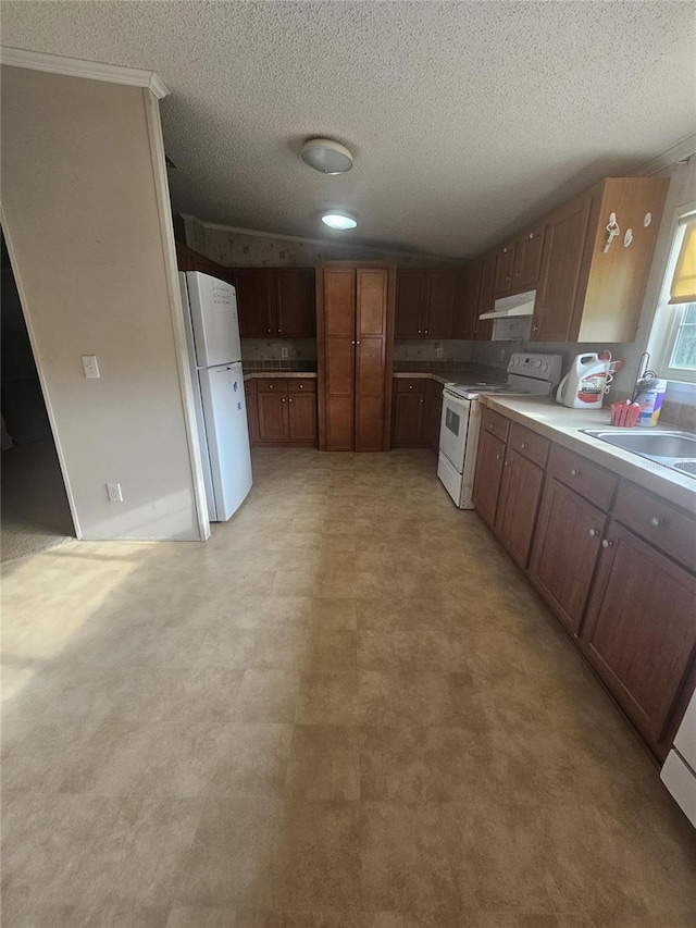 kitchen featuring white appliances, sink, and a textured ceiling