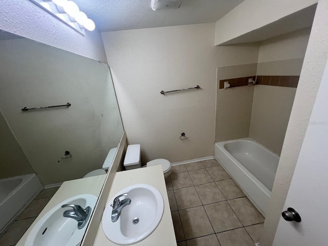 full bath featuring toilet, baseboards, a sink, and tile patterned floors