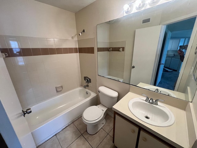 bathroom with visible vents, toilet, tile patterned floors, tub / shower combination, and vanity