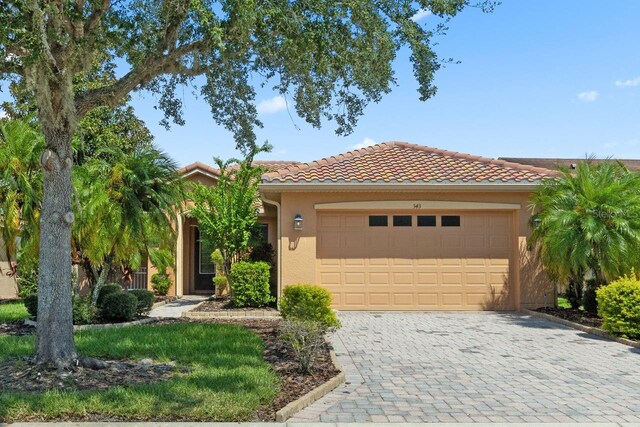 mediterranean / spanish home featuring a garage