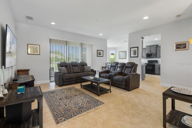 living area with light tile patterned floors, baseboards, visible vents, and recessed lighting