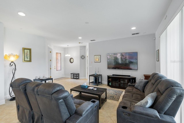 living area with light tile patterned floors, baseboards, and recessed lighting