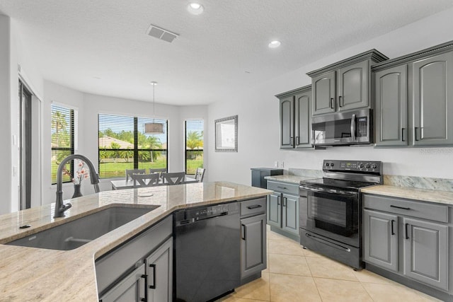 kitchen featuring sink, gray cabinetry, light tile patterned floors, and black appliances