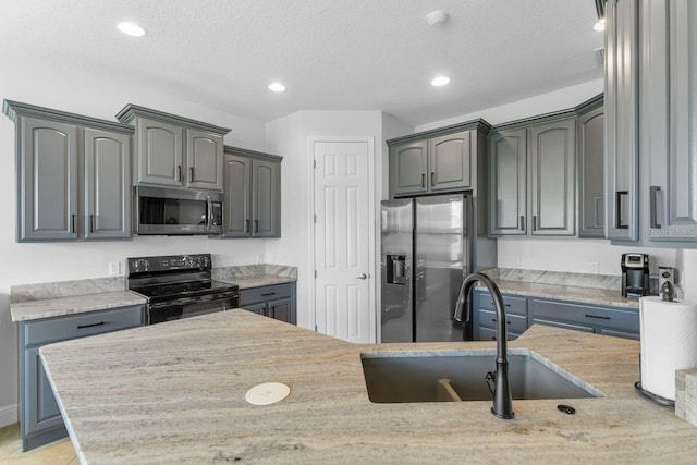 kitchen featuring sink, gray cabinets, and stainless steel appliances