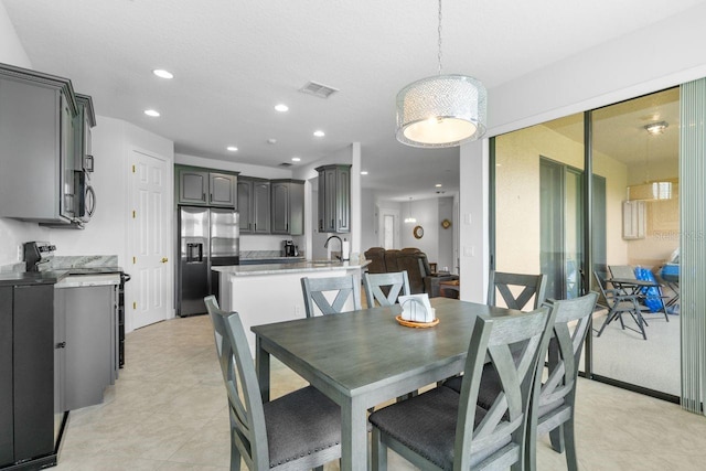 dining area with sink and light tile patterned floors