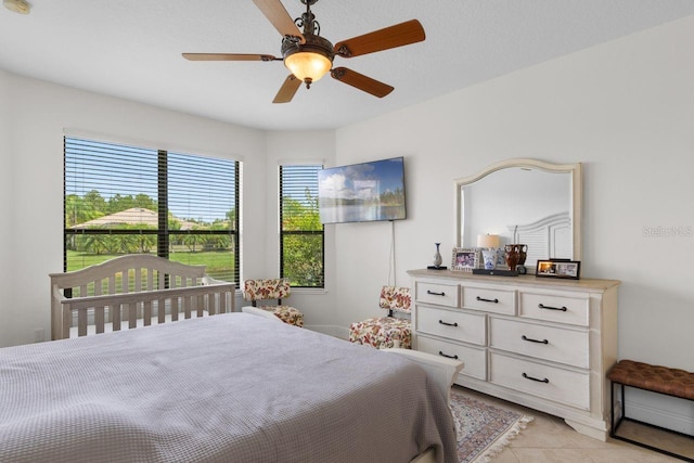 tiled bedroom with ceiling fan