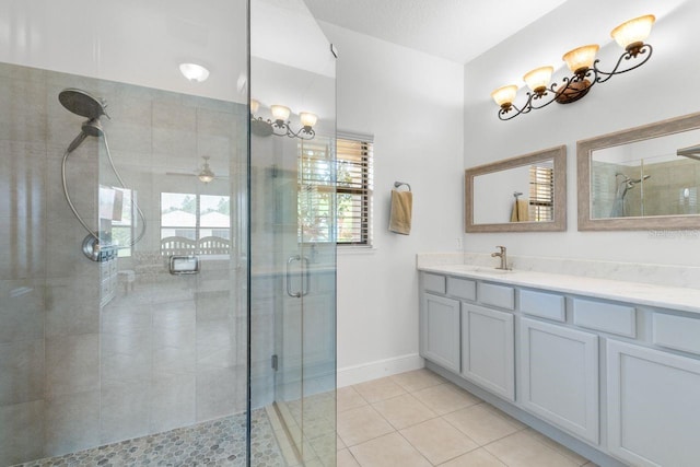 full bath with a shower stall, a ceiling fan, tile patterned flooring, and vanity