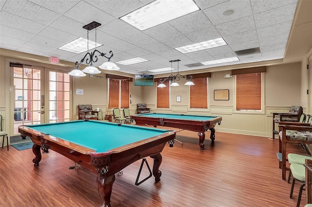 game room with french doors, wood-type flooring, a paneled ceiling, and billiards