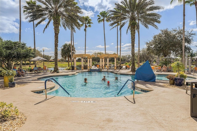 community pool with a patio and a pergola