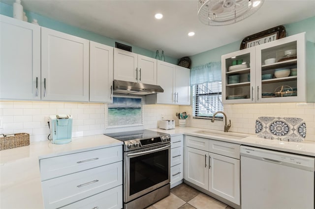 kitchen with stainless steel electric range oven, decorative backsplash, sink, and white dishwasher