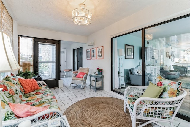 living room featuring a textured ceiling and light tile patterned flooring