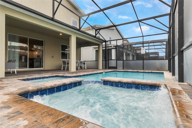 view of pool featuring glass enclosure, a patio area, and pool water feature