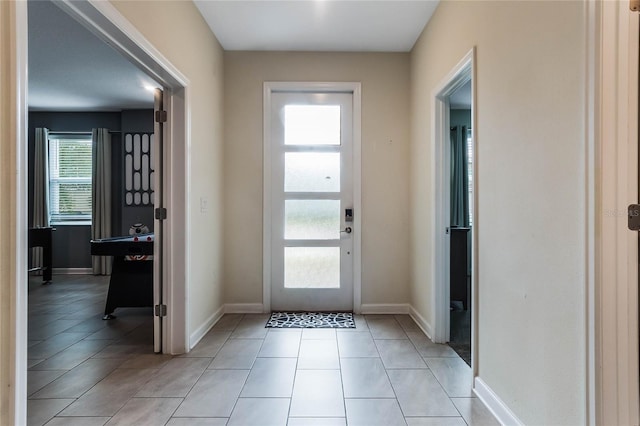 foyer with light tile patterned floors and a healthy amount of sunlight