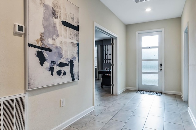 entryway with light tile patterned floors