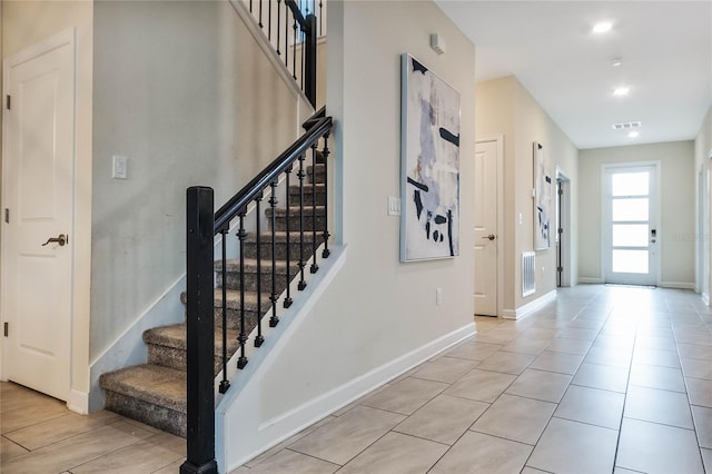 staircase featuring tile patterned floors