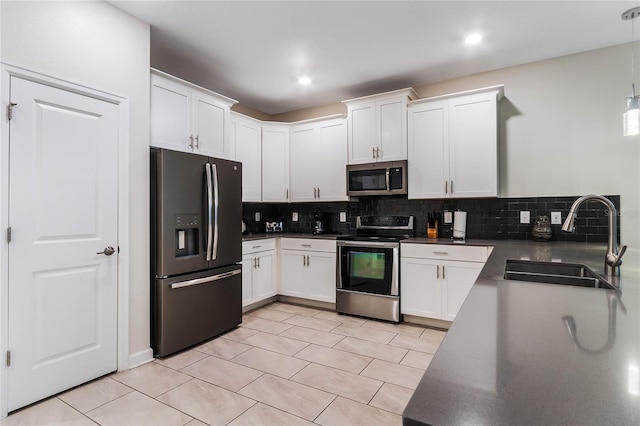 kitchen featuring sink, decorative backsplash, appliances with stainless steel finishes, and light tile patterned floors