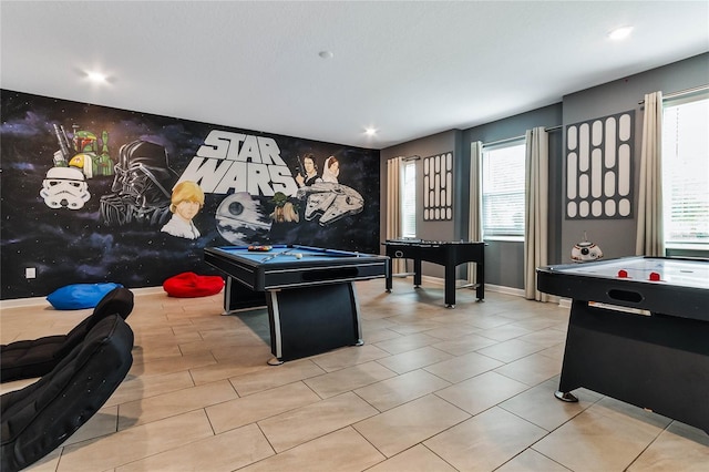 game room with a wealth of natural light, light tile patterned flooring, and pool table