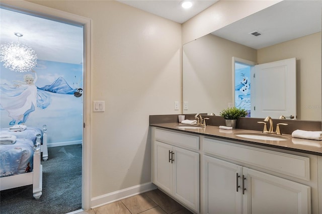 bathroom featuring double sink vanity and an inviting chandelier