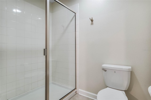 bathroom featuring walk in shower and toilet