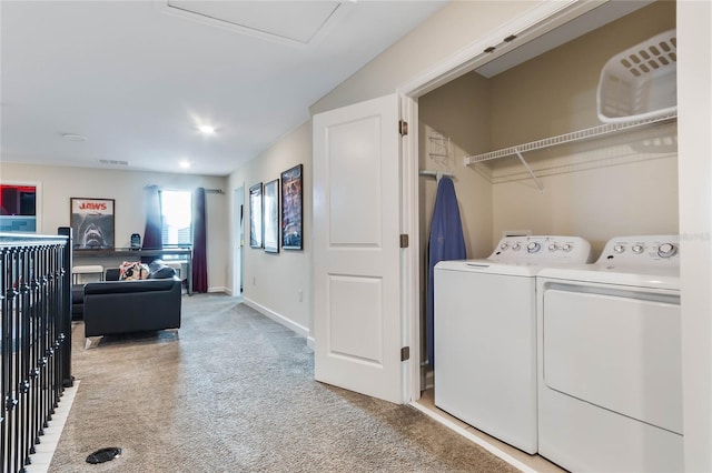 laundry room featuring washing machine and clothes dryer and light carpet