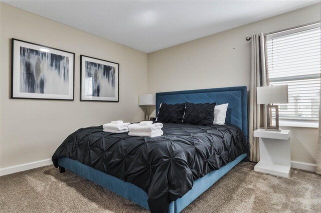 carpeted bedroom with multiple windows