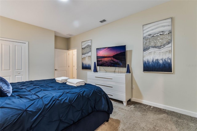 bedroom with a closet and light colored carpet