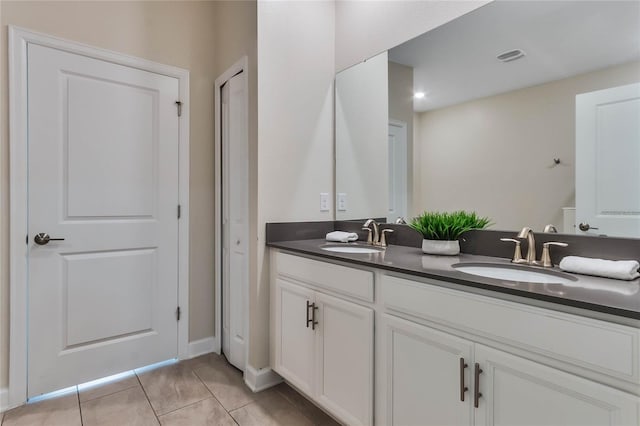 bathroom featuring double vanity and tile patterned flooring