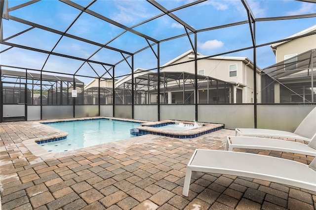 view of pool featuring a lanai, an in ground hot tub, and a patio