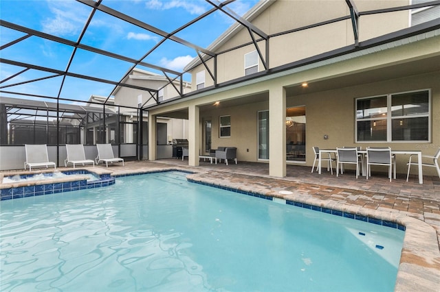 view of pool with an in ground hot tub, grilling area, a patio area, and a lanai