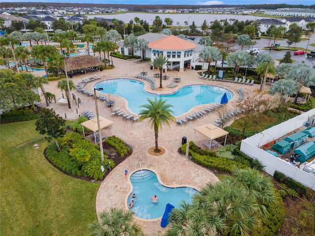 view of pool with a patio area and a water view