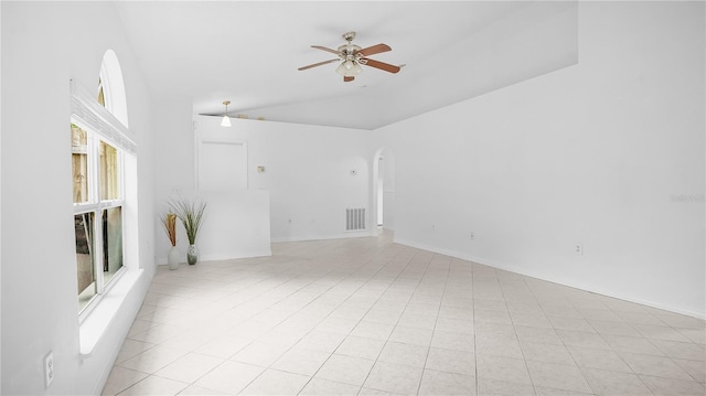 interior space with ceiling fan, light tile patterned flooring, and lofted ceiling