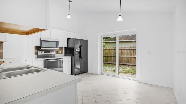 kitchen featuring stainless steel range with electric cooktop, black fridge, high vaulted ceiling, light tile patterned floors, and sink