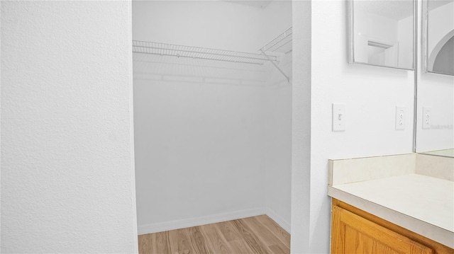 spacious closet featuring light hardwood / wood-style flooring