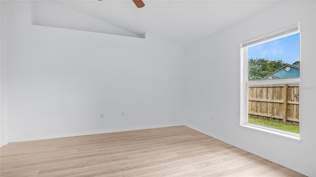 spare room featuring ceiling fan, light hardwood / wood-style floors, and lofted ceiling