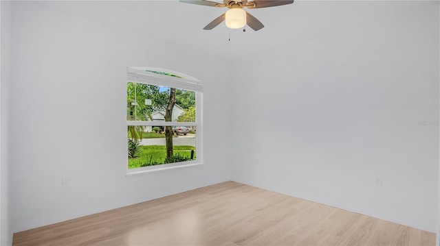 spare room featuring ceiling fan and light hardwood / wood-style flooring