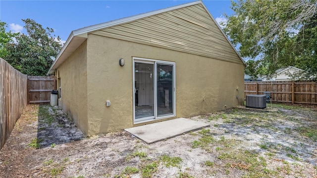 back of property featuring central air condition unit