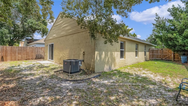 view of home's exterior with central air condition unit, a patio area, and a yard