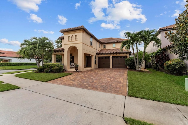 mediterranean / spanish home with a front yard