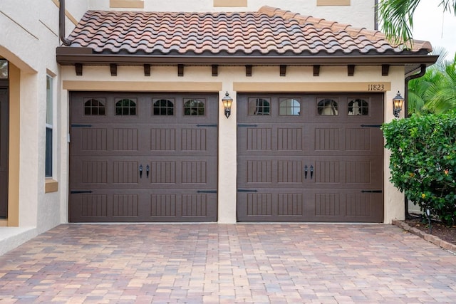 garage featuring decorative driveway