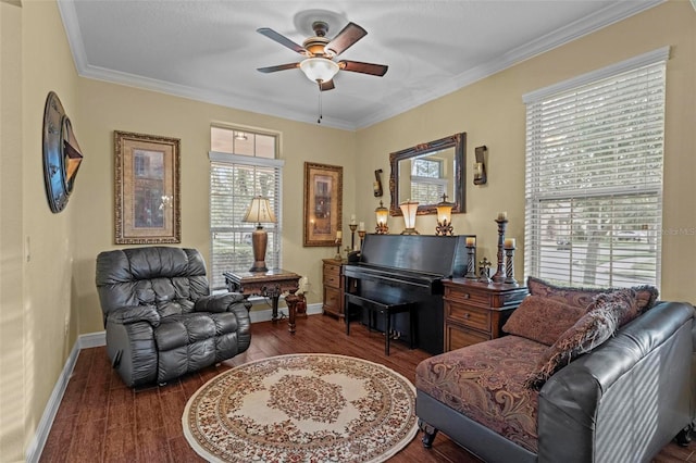 living area featuring dark hardwood / wood-style flooring, ornamental molding, and ceiling fan