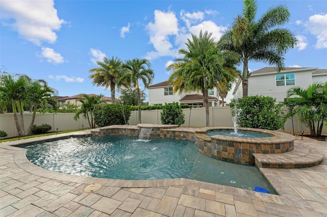 view of swimming pool with an in ground hot tub, a patio area, and pool water feature