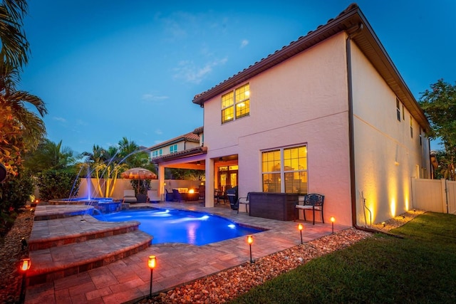 view of pool with pool water feature and a patio