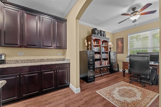 office space featuring ceiling fan, crown molding, a textured ceiling, and hardwood / wood-style flooring