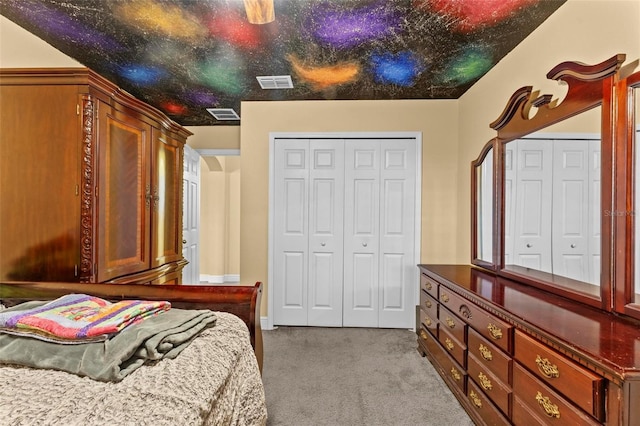 carpeted bedroom featuring a closet, visible vents, and ceiling fan